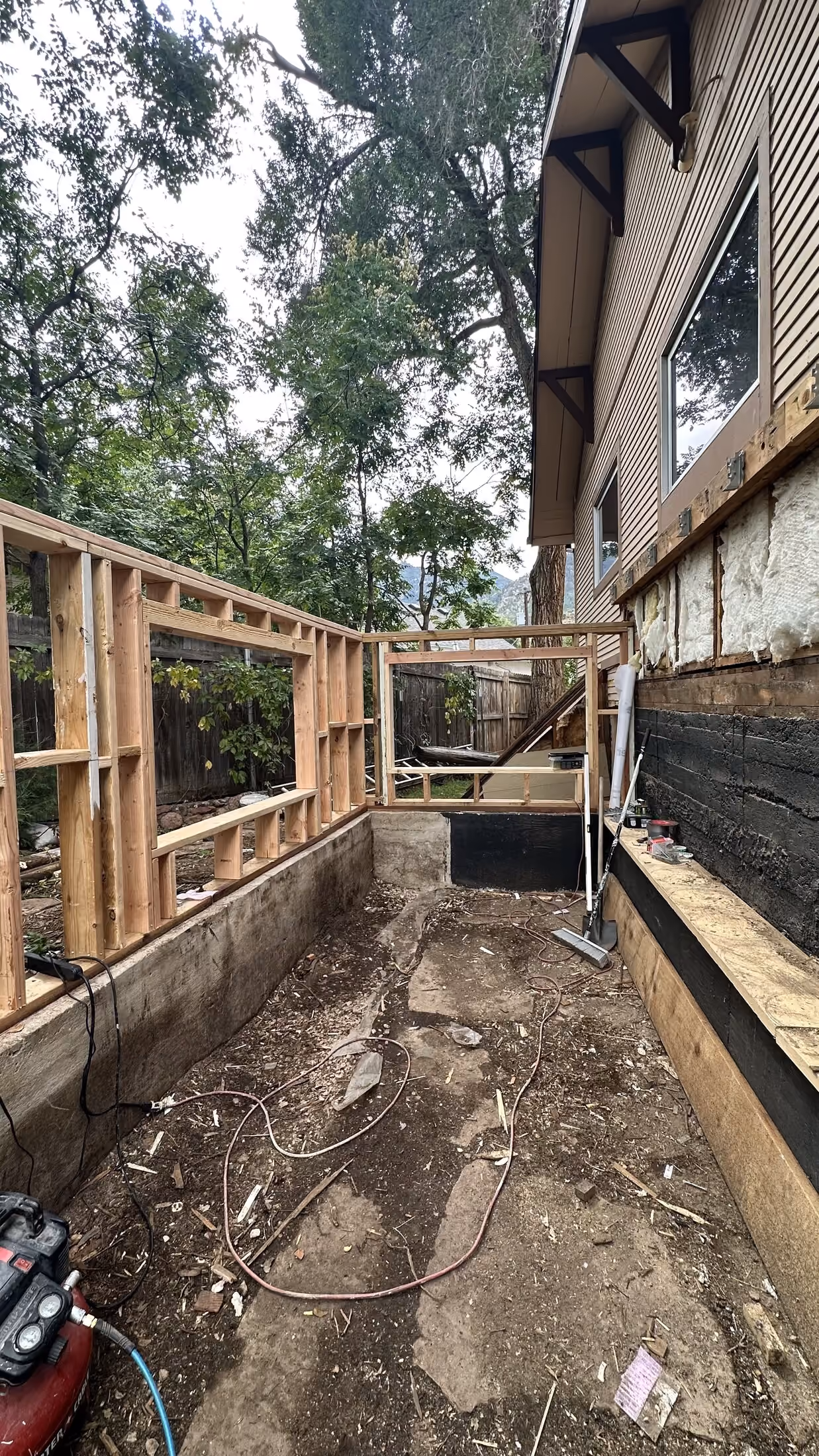 Addition footprint with new wall framing in progress